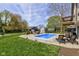 Backyard view showcasing an in-ground pool, patio, deck and well-manicured lawn, perfect for outdoor entertaining at 4977 Beechwood Rd, Avon, IN 46123