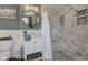 A beautifully designed bathroom featuring a marble tiled shower and a decorative mirror at 4977 Beechwood Rd, Avon, IN 46123