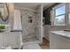 Bathroom featuring a shower with marble subway tile and a double vanity at 4977 Beechwood Rd, Avon, IN 46123