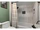 Updated bathroom showcases sleek tile work and a convenient shower niche for storage at 4977 Beechwood Rd, Avon, IN 46123