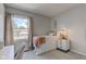 Cozy bedroom with a comfy bed, side table, and a window view of the outdoors at 4977 Beechwood Rd, Avon, IN 46123