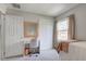 Well-lit bedroom features a vanity area, closet space, and a window with natural light at 4977 Beechwood Rd, Avon, IN 46123