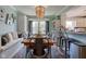 Inviting dining room with a wooden table, metal chairs, bead chandelier, and bench seating at 4977 Beechwood Rd, Avon, IN 46123