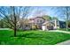 Two-story home featuring a well-manicured lawn, brick and siding exterior, and an attached two-car garage in a verdant setting at 4977 Beechwood Rd, Avon, IN 46123
