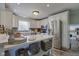 Well-lit kitchen with white cabinetry, a stainless steel refrigerator, and stylish countertops at 4977 Beechwood Rd, Avon, IN 46123