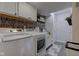 Well-organized laundry room equipped with modern washer and dryer, stylish wallpaper, and ample storage at 4977 Beechwood Rd, Avon, IN 46123