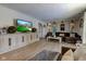 Inviting living room featuring hardwood floors, a large entertainment center, and cozy seating arrangements at 4977 Beechwood Rd, Avon, IN 46123