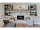 Inviting living room featuring a cozy fireplace, built-in shelving, and stylish decorative accents at 4977 Beechwood Rd, Avon, IN 46123