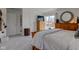 A main bedroom with a wooden dresser, large windows, and neutral colored walls at 4977 Beechwood Rd, Avon, IN 46123