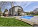 Backyard with a sparkling pool, dining area, upper balcony, and landscaped surroundings at 4977 Beechwood Rd, Avon, IN 46123