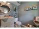 Cozy powder room with charming decor, a decorative mirror, and a vintage-style vanity at 4977 Beechwood Rd, Avon, IN 46123