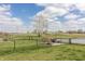 Expansive fenced backyard overlooking serene pond and lush green space on a sunny day at 5007 Avian Ln, Indianapolis, IN 46235