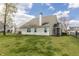 Spacious backyard featuring a well-maintained lawn, and a screened-in porch for outdoor enjoyment at 5007 Avian Ln, Indianapolis, IN 46235
