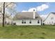 Expansive backyard with lush green grass and a view of the home's rear exterior at 5007 Avian Ln, Indianapolis, IN 46235