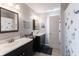Bright bathroom with dual sinks, large mirrors, and plenty of counter space, offering a luxurious and functional design at 5007 Avian Ln, Indianapolis, IN 46235