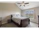 Serene bedroom with a queen-sized bed, a large window overlooking the pond, and ample natural light for a peaceful retreat at 5007 Avian Ln, Indianapolis, IN 46235