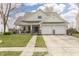 Charming two-story home with a well-maintained lawn and a two-car garage at 5007 Avian Ln, Indianapolis, IN 46235