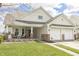 Inviting two-story home with a covered porch and a two-car garage at 5007 Avian Ln, Indianapolis, IN 46235