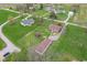 Aerial shot featuring the home and surrounding neighborhood with large lots, green lawns and mature trees at 5551 W 200 N, Greenfield, IN 46140