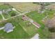 The aerial image shows a house and neighboring properties set on green lawns, surrounded by mature trees at 5551 W 200 N, Greenfield, IN 46140