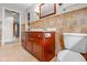 Traditional bathroom featuring a single sink vanity with a toilet and tiled walls at 5551 W 200 N, Greenfield, IN 46140