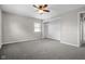 Bright bedroom featuring neutral walls, carpet, a window, a ceiling fan and a closet at 5551 W 200 N, Greenfield, IN 46140
