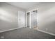 Neutral bedroom with soft carpet, featuring two doors and ample natural lighting at 5551 W 200 N, Greenfield, IN 46140