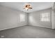 Bright bedroom featuring neutral walls, carpet, two windows, and a ceiling fan at 5551 W 200 N, Greenfield, IN 46140
