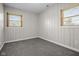 Bedroom featuring white paneled walls, carpet, and windows at 5551 W 200 N, Greenfield, IN 46140