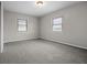 Neutral bedroom with plush carpet, white walls, and natural light from the windows at 5551 W 200 N, Greenfield, IN 46140