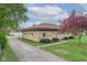 Charming stone home with well-maintained lawn and mature trees at 5551 W 200 N, Greenfield, IN 46140