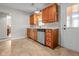 Cozy kitchen featuring wood cabinets, updated sink and countertops, and natural light at 5551 W 200 N, Greenfield, IN 46140