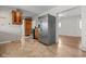 Spacious kitchen featuring stainless steel refrigerator, wood cabinets, and durable flooring at 5551 W 200 N, Greenfield, IN 46140