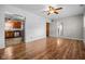 Bright living room with wood floors, shiplap accent wall, and modern ceiling fan at 5551 W 200 N, Greenfield, IN 46140