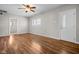 Spacious living room with wood flooring, a bright window, and neutral paint at 5551 W 200 N, Greenfield, IN 46140