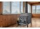 Close-up of the vintage wood burning stove in sunroom with window views at 5551 W 200 N, Greenfield, IN 46140