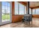 Bright sunroom featuring a wood-burning stove and views of the property at 5551 W 200 N, Greenfield, IN 46140