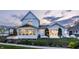 A beautiful two-story house featuring a patio and meticulously maintained landscaping at 5682 Upper Garden Way, Zionsville, IN 46077