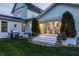 A backyard view of a beautiful home featuring a patio and meticulously maintained landscaping at 5682 Upper Garden Way, Zionsville, IN 46077