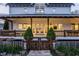 Inviting two-story home boasts a covered front porch, wood railing, fenced yard, and beautifully landscaped front yard at 5682 Upper Garden Way, Zionsville, IN 46077