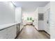 Hallway with a stylish bar area, featuring white cabinetry and beverage refrigerator at 5682 Upper Garden Way, Zionsville, IN 46077