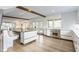 Open concept kitchen with stainless steel appliances, an island and adjacent dining area at 5682 Upper Garden Way, Zionsville, IN 46077
