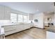 Modern kitchen with white cabinetry, stainless steel appliances, and a large window offering natural light at 5682 Upper Garden Way, Zionsville, IN 46077