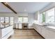 Modern kitchen with stainless steel appliances, wood floors, and bright white cabinetry at 5682 Upper Garden Way, Zionsville, IN 46077