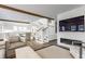 Bright living room features fireplace, staircase, and seamless open flow to the modern kitchen at 5682 Upper Garden Way, Zionsville, IN 46077