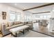 Bright living room with shiplap walls, exposed beams, and open floorplan that flows into a modern kitchen at 5682 Upper Garden Way, Zionsville, IN 46077