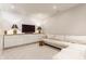 Cozy living room with a large sofa, entertainment unit, and neutral color palette at 5682 Upper Garden Way, Zionsville, IN 46077