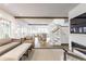 Open concept living room with fireplace, staircase, and views of the modern kitchen and backyard at 5682 Upper Garden Way, Zionsville, IN 46077
