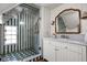 Stylish bathroom with a unique shower featuring green striped tiling and marble countertop vanity at 5946 N New Jersey St, Indianapolis, IN 46220