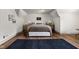 A spacious bedroom with light hardwood floors and a dark rug, offering a serene ambiance at 5946 N New Jersey St, Indianapolis, IN 46220